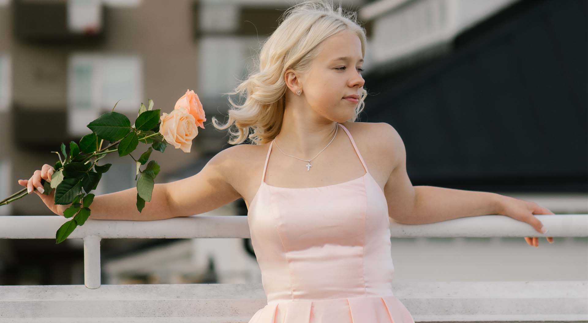 Confirmed girl with a rose in an urban setting