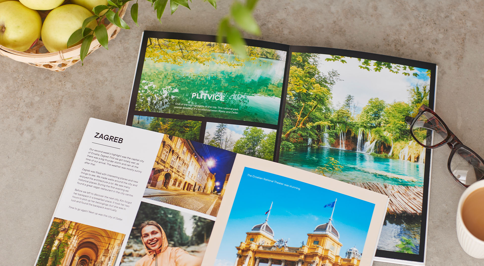Two opened photo books which are created with photos from a trip to Croatia