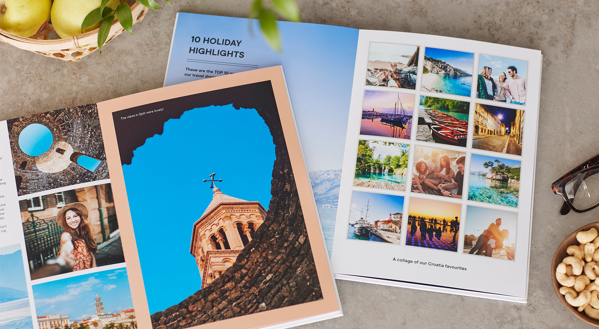 Two opened travel photo books pictured on a table