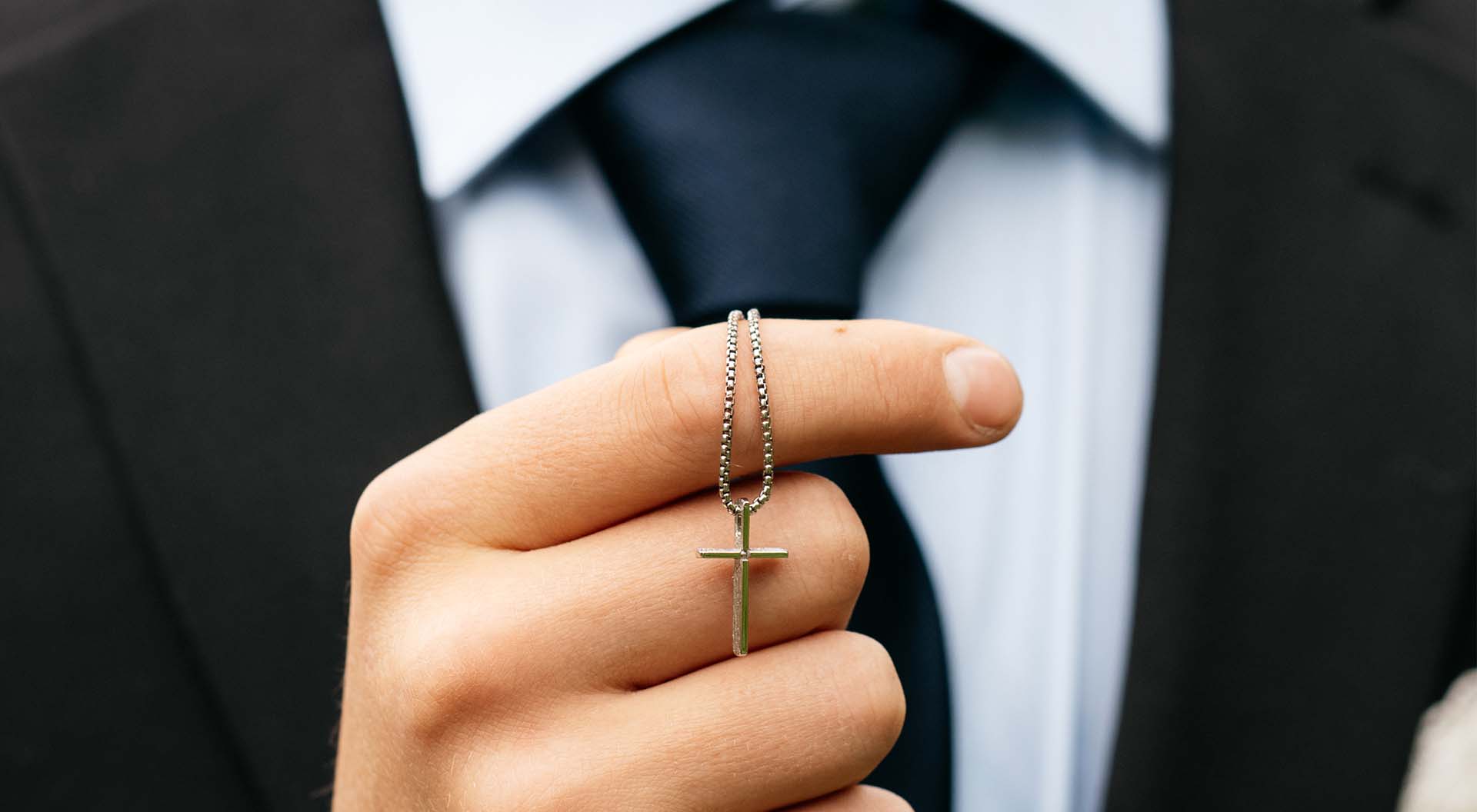 Close-up of a confirmation cross in a hand