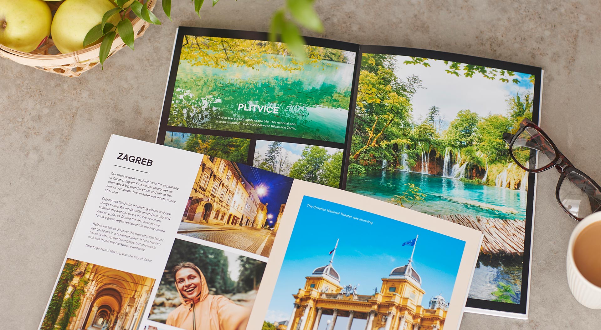 Two opened photo books which are created with photos from a trip to Croatia