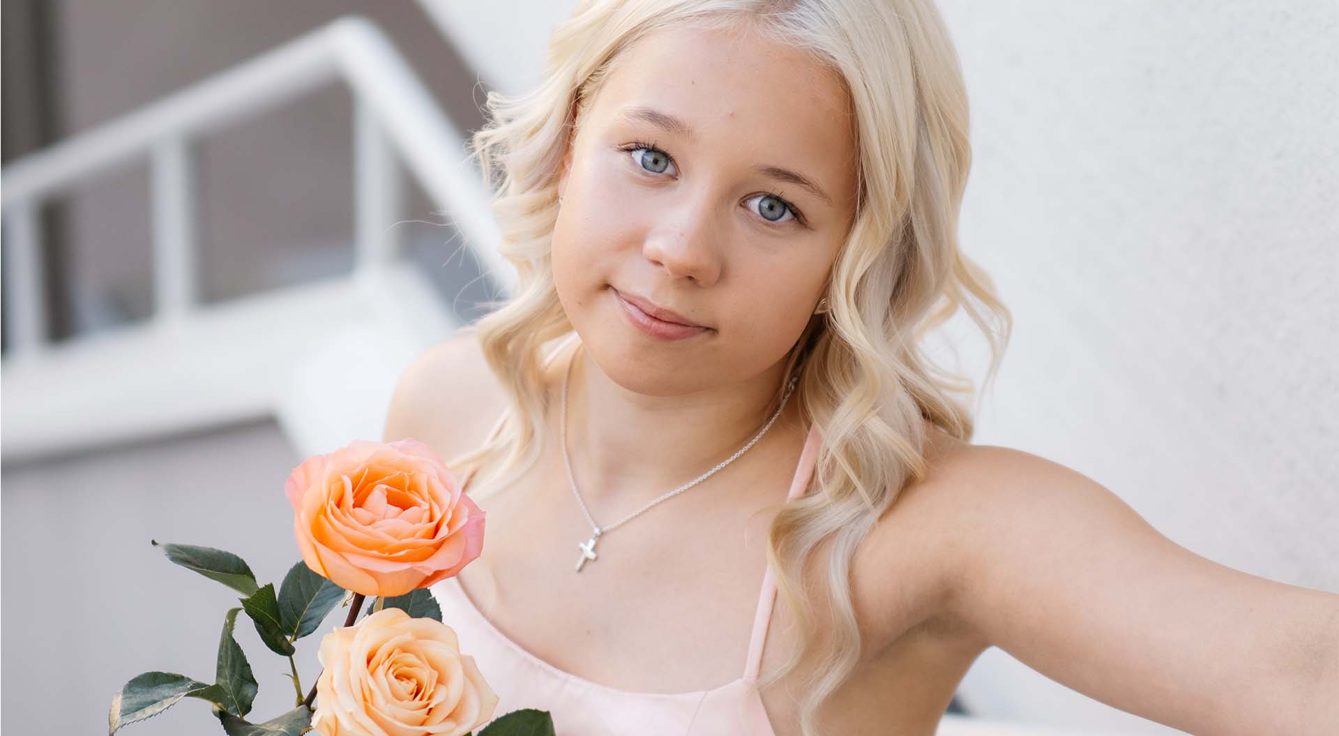 Girl photographed from above, holding a rose